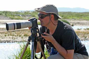 Dr. Art taking a photo with camera on a tripod.
