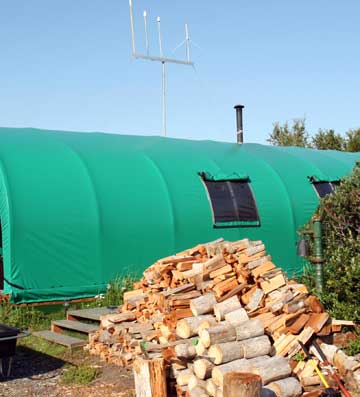 Our camp with cut wood piled up in front.