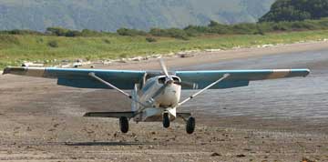 Airplane landing on the beach.