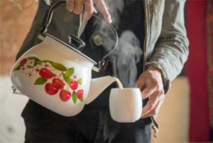 Pouring tea from a kettle