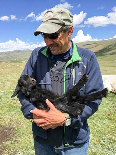 Dr. P holding a baby goat