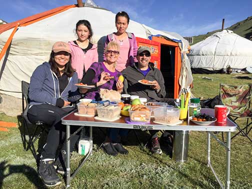 Our cooks posing with us as we eat breakfast outside in the beautiful sun