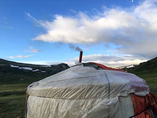 A Ger with smoke coming out of its stovepipe