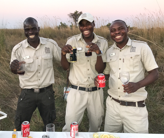 Moremi guides serving drinks