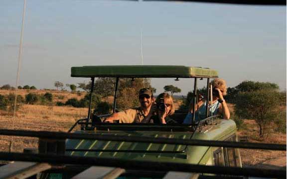 3 people in safari vehicle