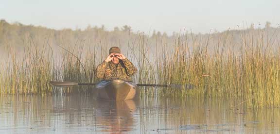 Hiding in reeds in the kayak