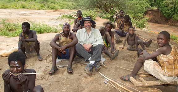 Dr. P sitting with the Hadza after a hunt