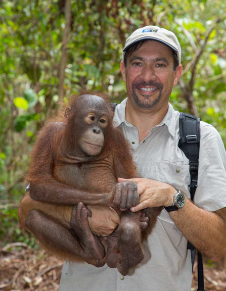 Dr. P with a baby orangutan in his arms