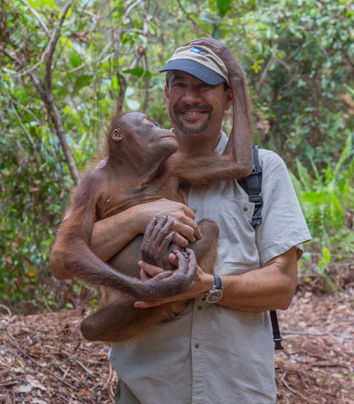 Dr. P holding a baby orangutan