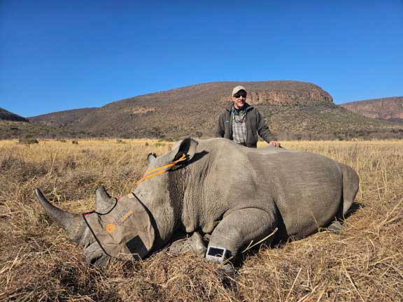 Dr. P with a sedated rhino for a radio collar