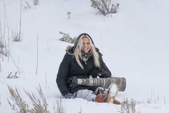 Dr. P's assistant photographer sitting in the snow with a telephoto lens