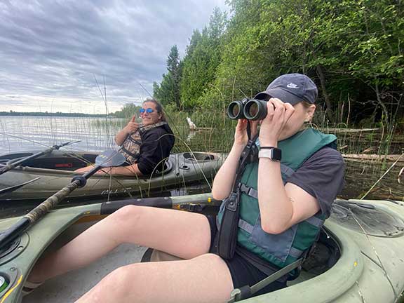 Scanning for eagles with binoculars from a kayak.