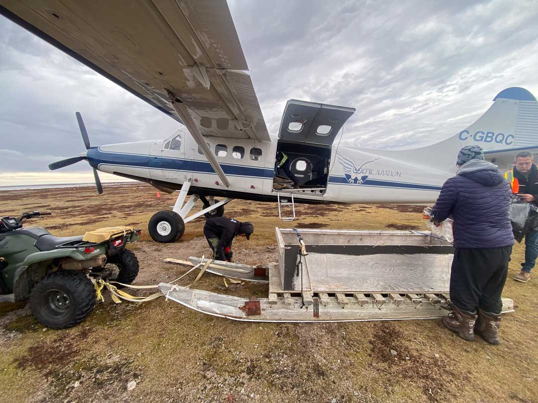 Sled hauling supplies to bush plane.