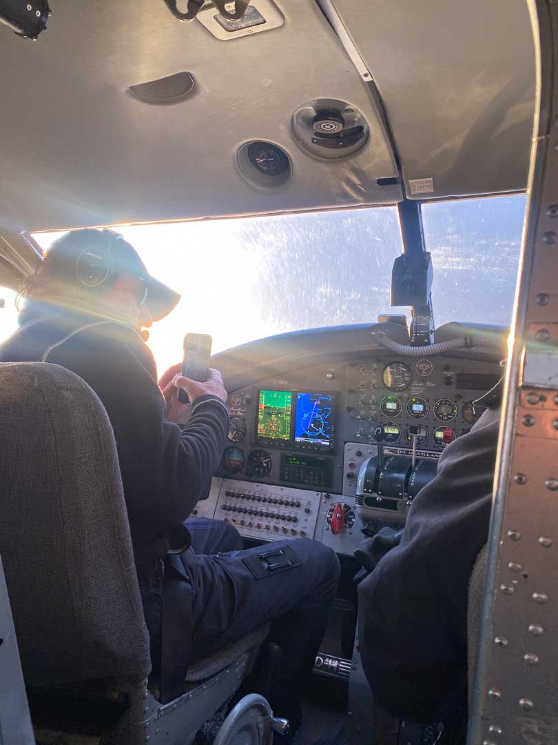 Pilot of bush plane taking a photo.