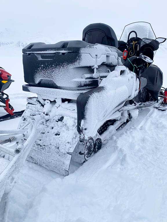 Snow on the snowmobile at the end of a days ride.