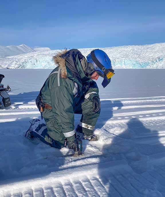 Polar bear snowmobile trip checking the ice.