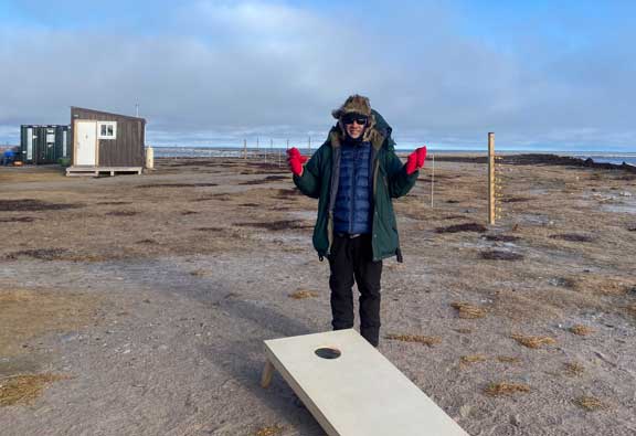 Playing corn hole in the camp.